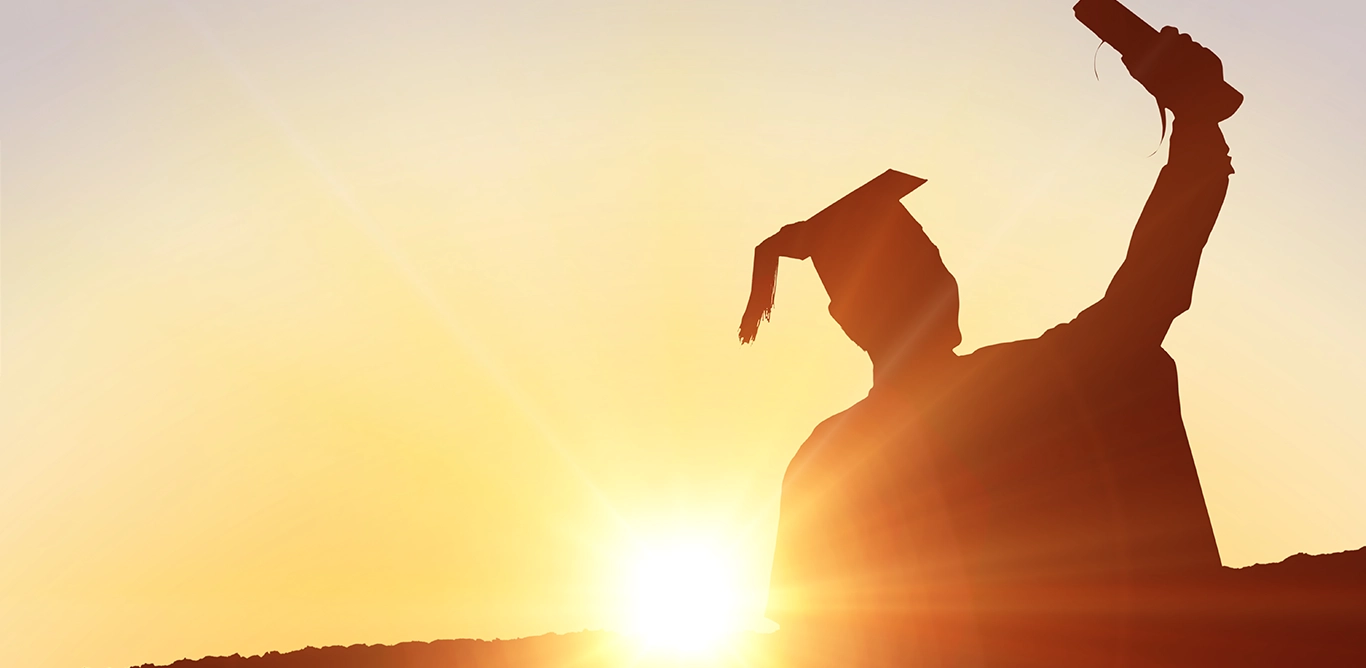 Silhouette of a graduate holding their diploma